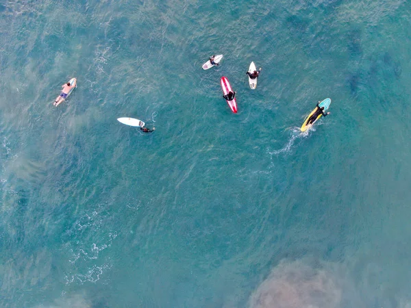 Aerial top view of surfers waiting the waves — ストック写真