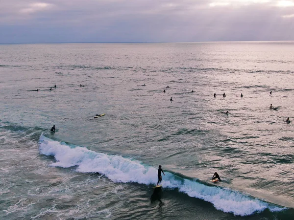 Aerial view of surfers waiting waves before sunset — 스톡 사진