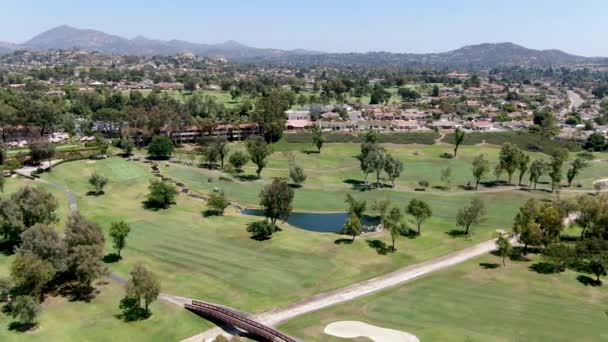 Aerial view of golf in upscale residential neighborhood. — Stock Video