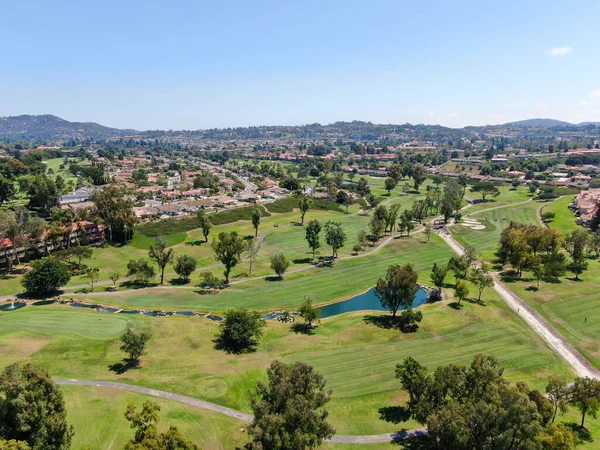 Aerial view of golf in upscale residential neighborhood. Stock Picture