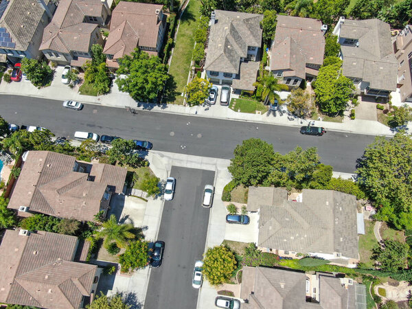Aerial top view of middle class subdivision neighborhood with residential villas next to each other in San Diego County, California, USA.