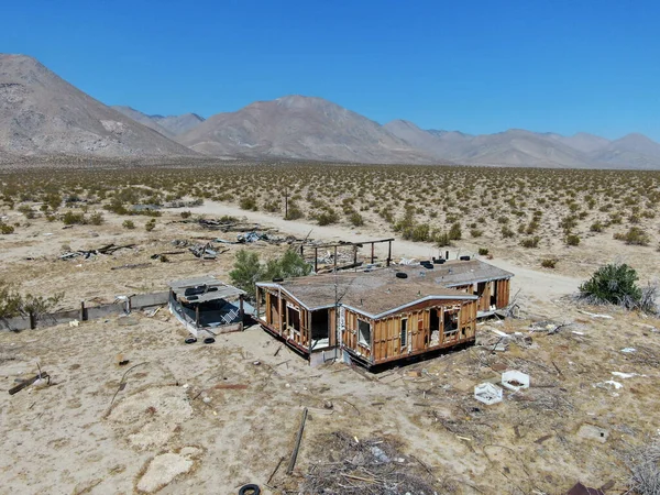 stock image Aerial view of abandoned houses and camper trailer in the middle of the desert