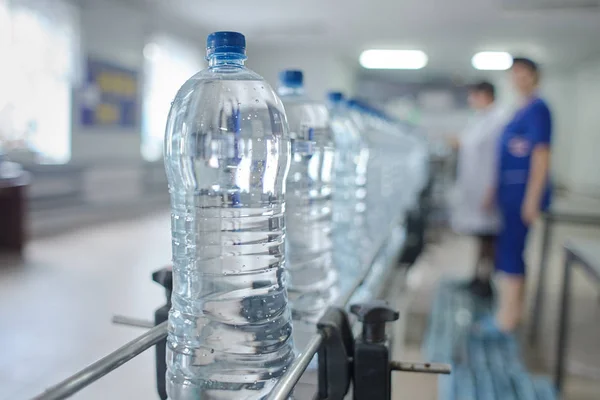 Pet bottle with natural water manufacturing. Soft focus