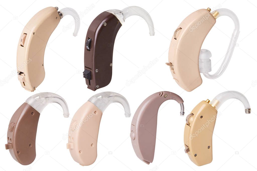 Set of old analog hearing aids on white background isolated, alternative to surgery