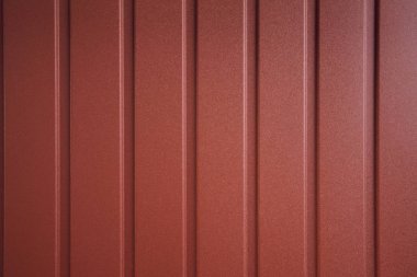 Seamless container pattern. Aluminum fence. Galvanized steel wall plate. Corrugated metal profiled panel. Metal rivets. Background of red metal siding, corrugated iron sheet for exterior decoration clipart