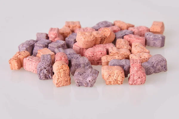 Various vitamins for kids on a white background. Studio lights. Assorted animal shaped multivitamins for kids. Chewable pills