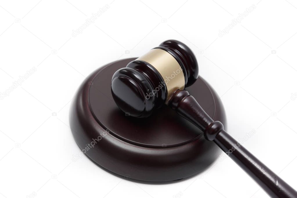 Wooden auctioneer or judges gavel for dispensing justice or knocking down sale prices agains white background