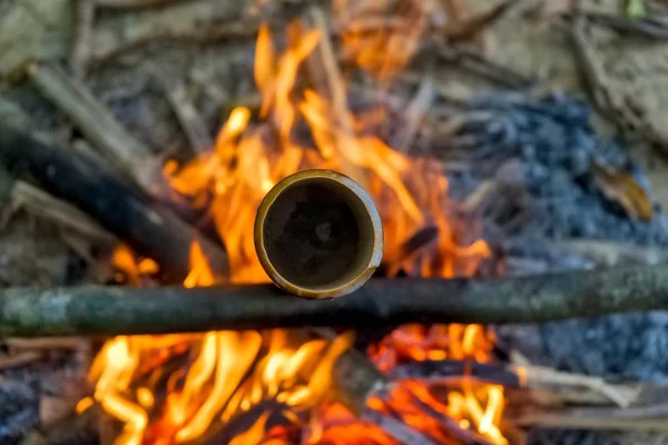 Water is heated inside a piece of Bamboo