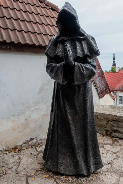 Black metal statue of a faceless monk in Tallinn