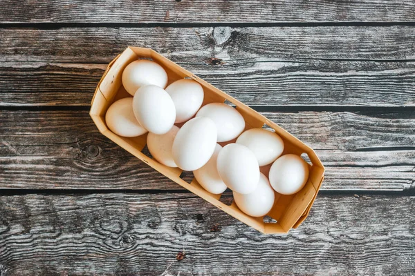 Eggs in a box. Eggs on a wooden table. Organic products
