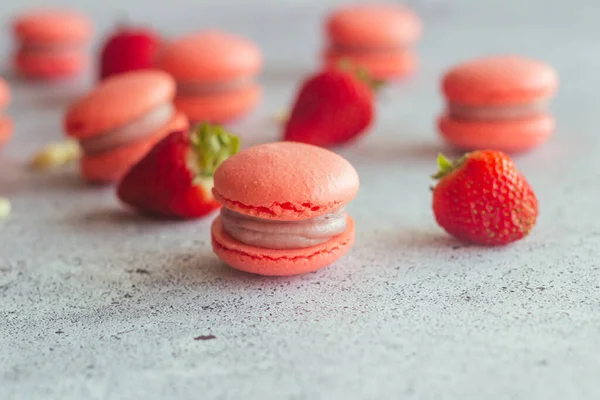 Macaroons. Delicious french desserts. Macaroons on the table. Macaroons with strawberries