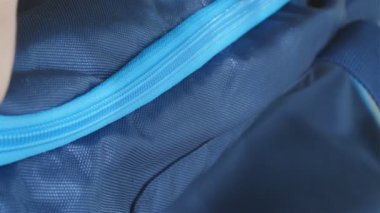 Bir çantanın fermuarının kadın parmaklarıyla açılıp kapatıldığı makro yakın çekim, yavaş çekim.