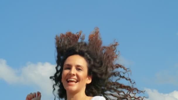 Счастливая Молодая Женщина Красивыми Кудрявыми Волосами Прыгает Голубой Фон Неба — стоковое видео