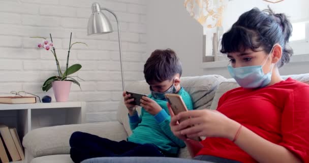 Zdravotní Koncepce Covid Dívka Chlapec Maskami Hraje Videohry Dvou Smartphonech — Stock video