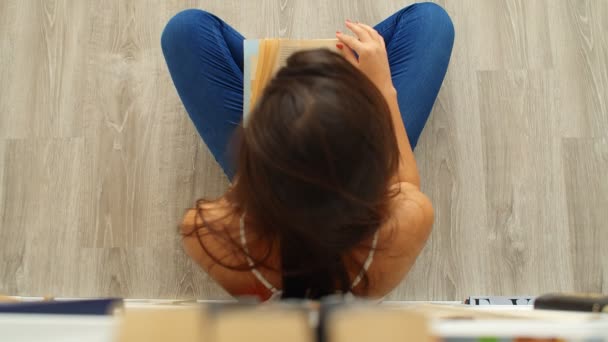 Young Woman Reading Book Sitting Floor Home Top View — Stock Video