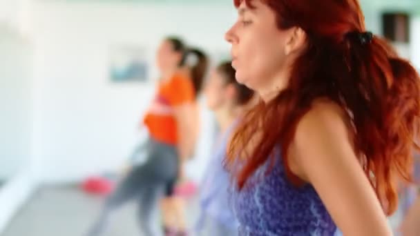 Dance fitness Zumba osztály csoport gyönyörű nők táncolnak élvezi edzés gyakorló koreográfia mozog egy oktató egy fitness stúdió, 4k lassított felvétel