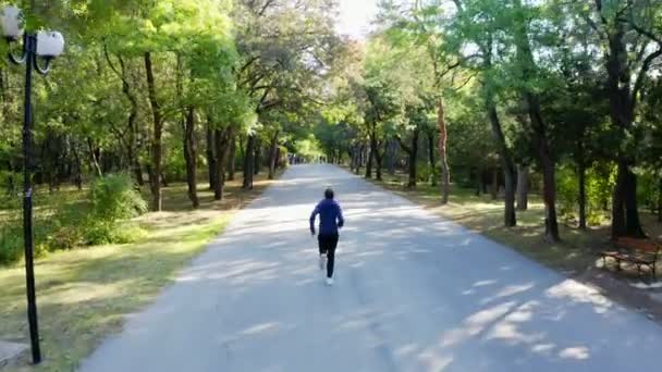 Tracking Drone Camera Man Running Jogging Autumn Park — Stock Video