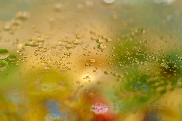 floating in the water abstract colorful, yellow oil drops