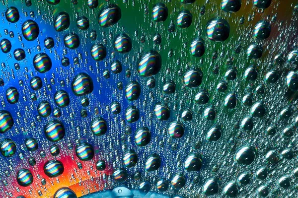 Macro of water drops on multicolor background — Stock Photo, Image