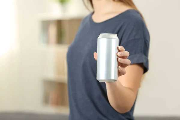 Closeup of a woman hand holding a soda drink can at home