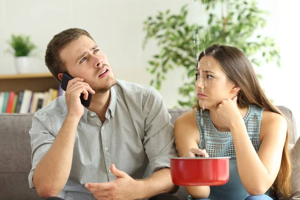 Desperate Couple Callling Insurance Worried Home Leaks Living Room — Stock Photo, Image