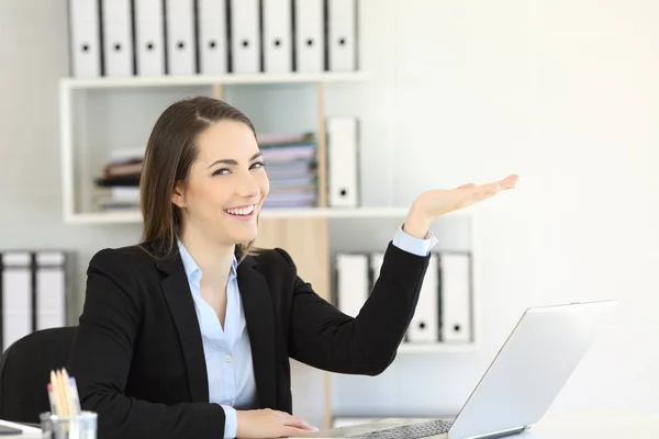 Happy office worker holding something with her palm looking at you