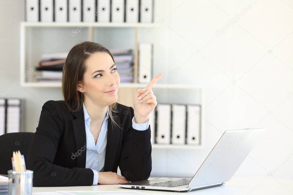 Relaxed office worker pointing at side to a blank white space