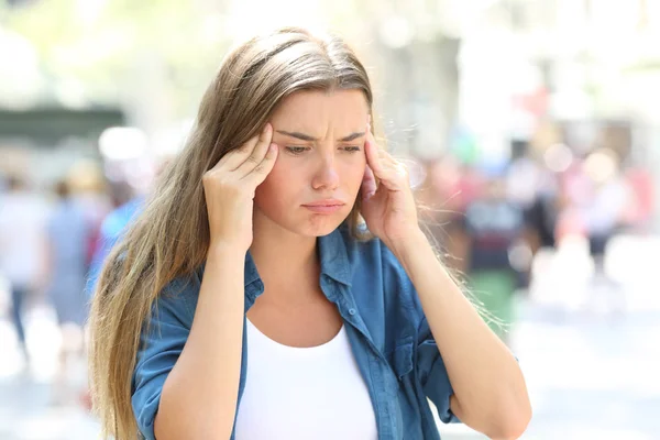 被强调的女孩抱怨痛苦在街道的头疼痛 — 图库照片