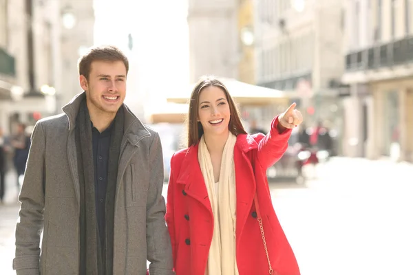 Front View Portrait Couple Walking Street Pointing Away — Stock Photo, Image