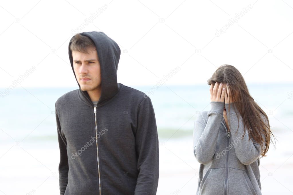 Couple break up on the beach with a man leaving girl alone