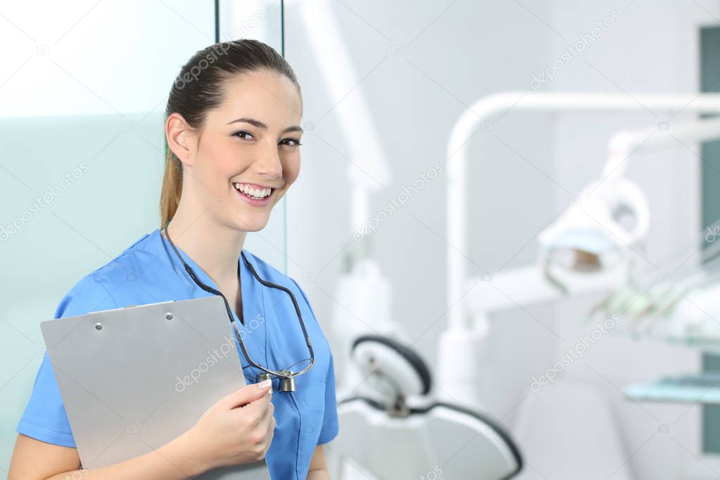 Happy dentst girl posing in a dental clinic interior