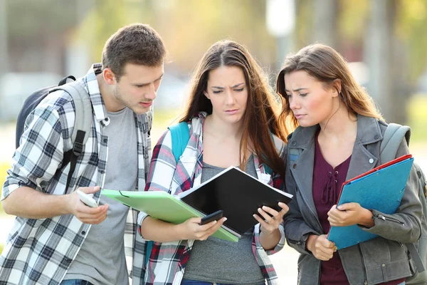 Drie Verward Studenten Controleren Aantekeningen Papier Voor Examen — Stockfoto