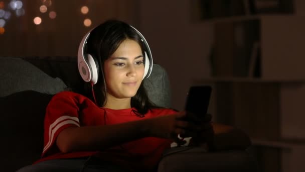 Happy Teen Selecting Song Singing Listening Music Headphones Smarphone Sitting — стоковое видео