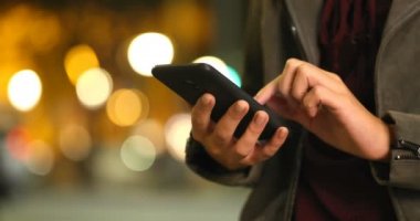 Gece sokakta akıllı telefon içeriğini görüntülemek bir moda kadın el yakın çekim