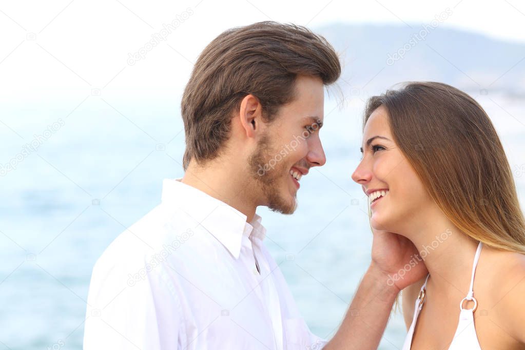Romantic couple ready to kiss on the beach on summer vacation