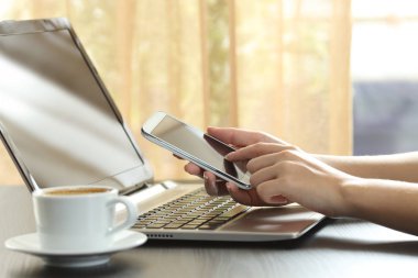 Bir smartphone bir tablo kullanarak bir kadın el yakın çekim