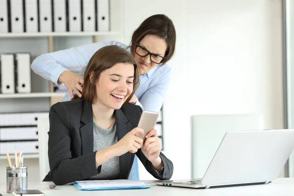 Furious office worker angry with her lazy colleague trying to strangle