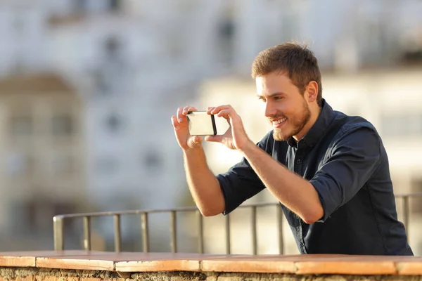 Happy Man Recording Videos Smarphone Town Background — стоковое фото