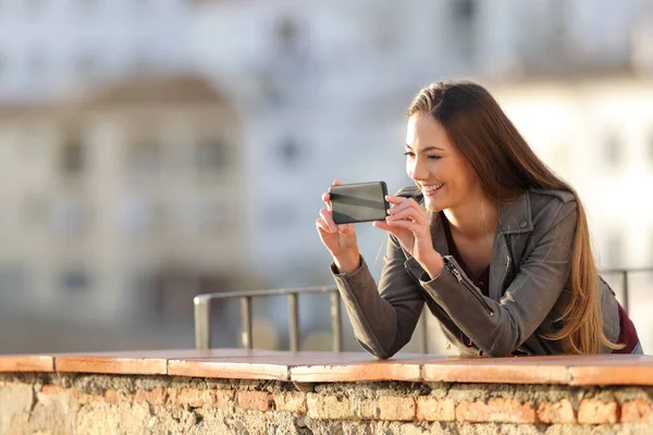 Happy Woman Recording Videos Taking Photos Smarphone Balcony Sunset — стоковое фото