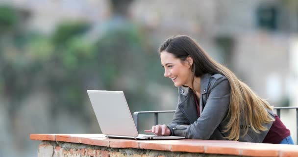 在农村公寓露台上 快乐的妇女在笔记本电脑上浏览在线内容 — 图库视频影像
