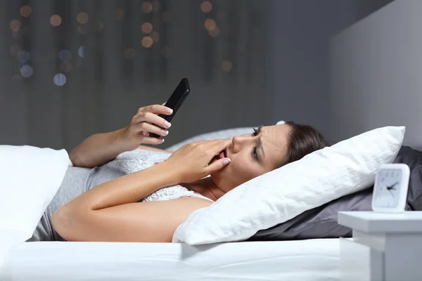 Worried Woman Consulting Bad Online News Smart Phone Lying Bed — Stock Photo, Image
