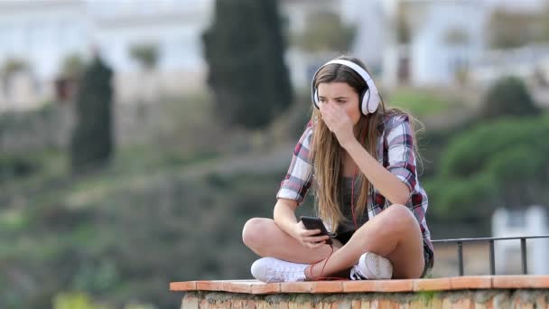 Triste Adolescente Escuchando Música Vacaciones Sentado Una Cornisa Una Ciudad — Vídeo de stock