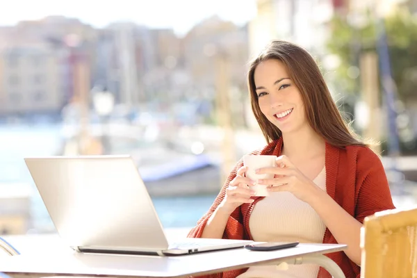 Mulher Feliz Com Laptop Segurando Uma Bebida Olhando Para Você — Fotografia de Stock