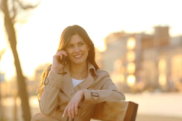 Mujer Feliz Hablando Por Teléfono Sentada Banco Parque Atardecer — Foto de Stock