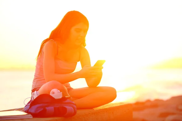 Estudante Usando Telefone Inteligente Pôr Sol Sentado Banco Praia — Fotografia de Stock