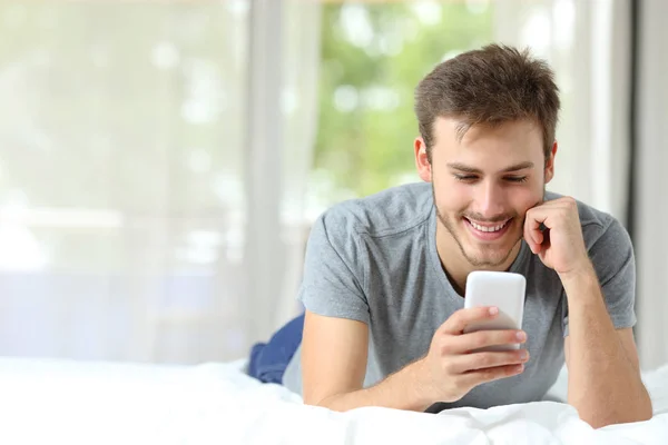 Front View Happy Man Using Smart Phone Bed Copy Space — Stock Photo, Image