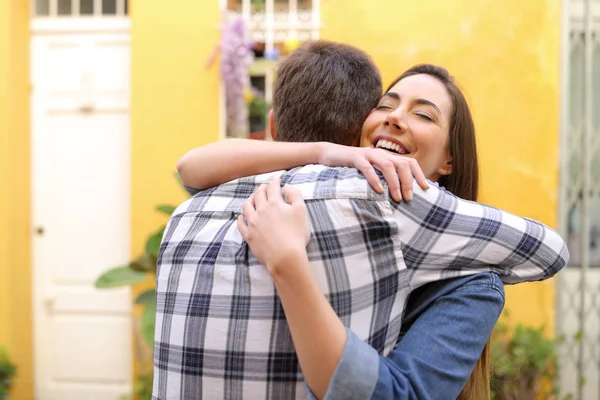 Gelukkige paar of vrienden knuffelen in een straat — Stockfoto