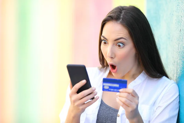 Verrast vrouw online met credit card buiten kopen — Stockfoto