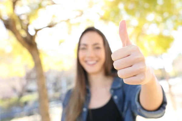 Glückliche Frau gestikuliert Daumen hoch in einem Park — Stockfoto