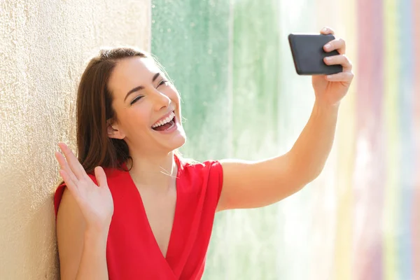 Femme heureuse prenant selfies dans une rue colorée — Photo